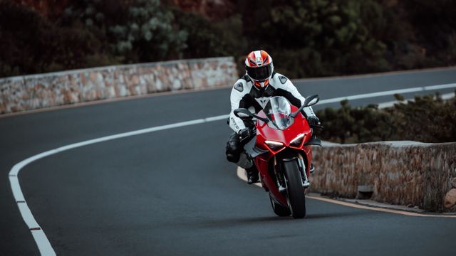 Motorcycle rider in city traffic and on highway